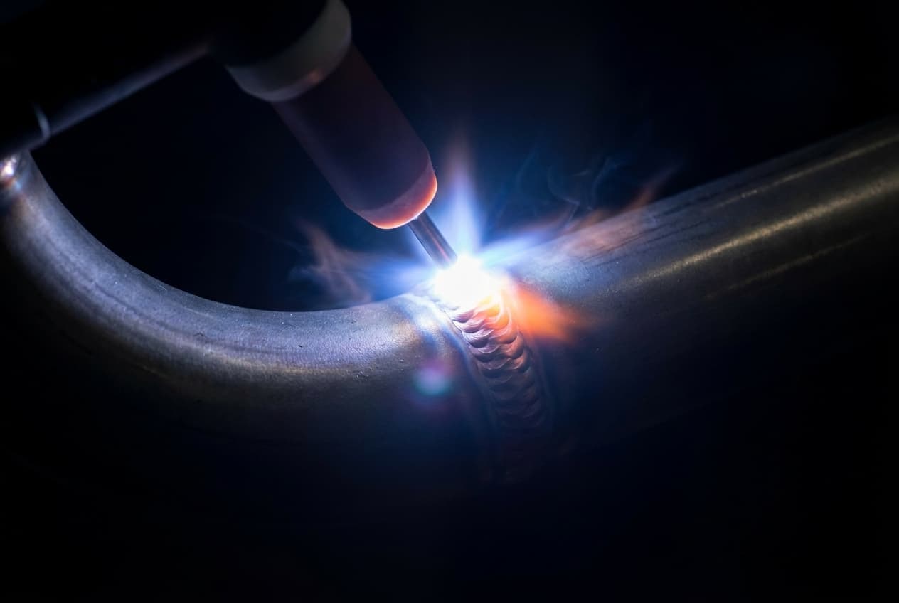 TIG welding arc on stainless pipe leaving a stack-of-dimes weld bead